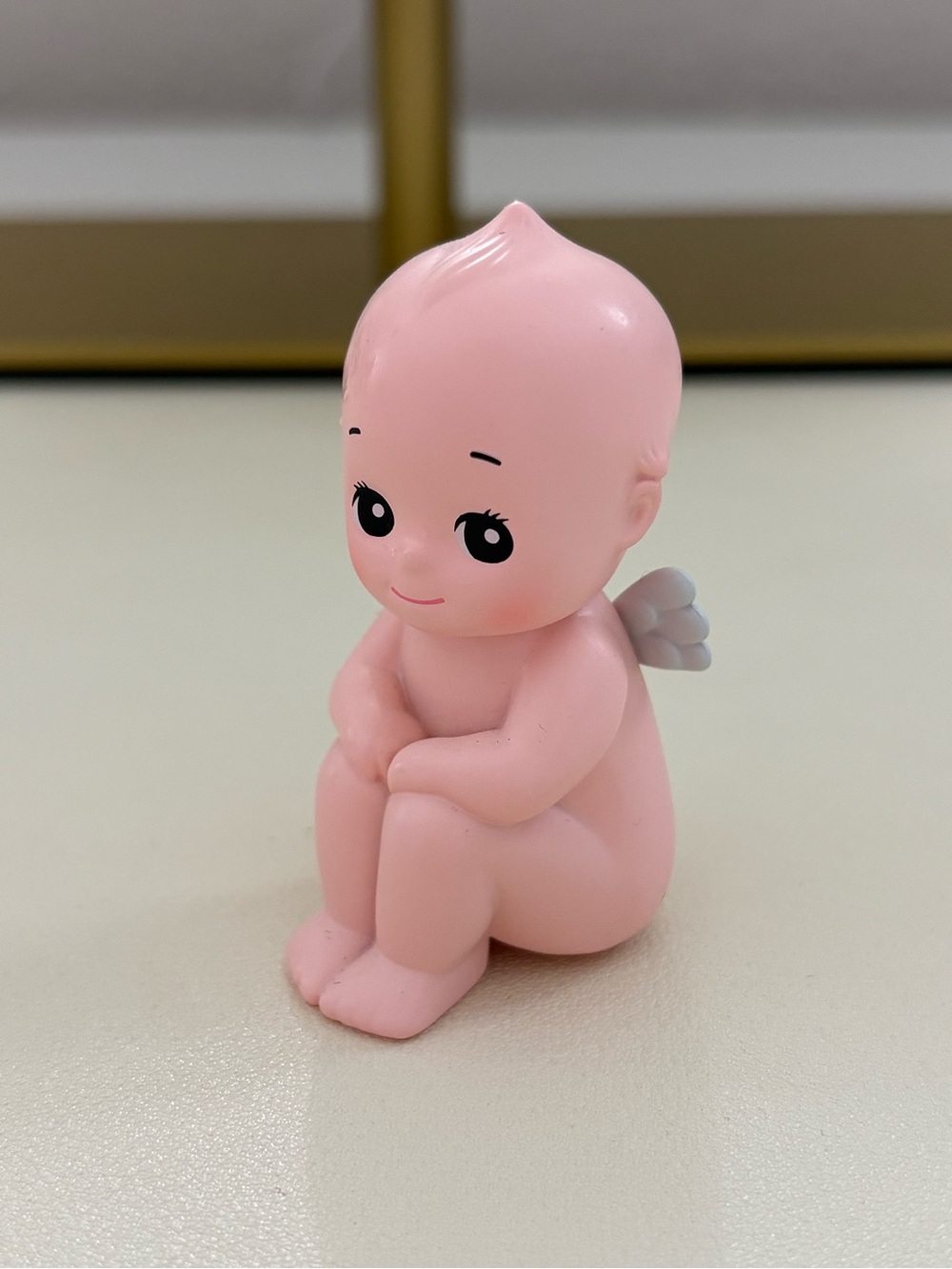 Kewpie sitting down doll